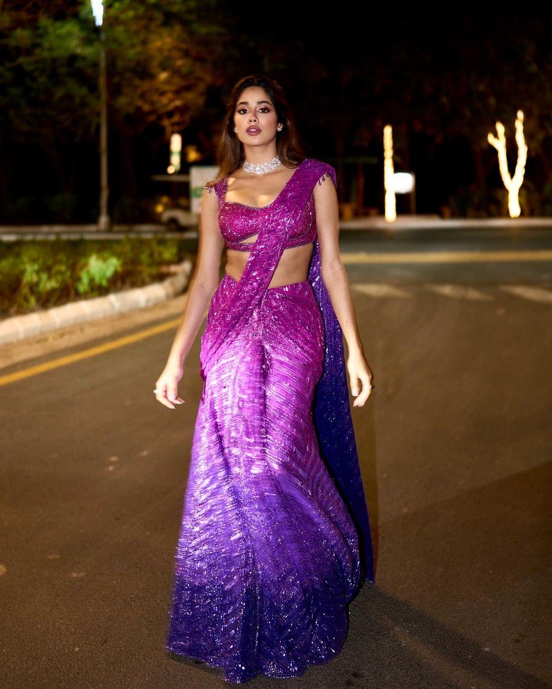 In her next outfit, she effortlessly wrapped herself in a six-yard saree that oozed grace. The stunning sequined saree had a captivating ombre pattern, transitioning from pink to purple. 