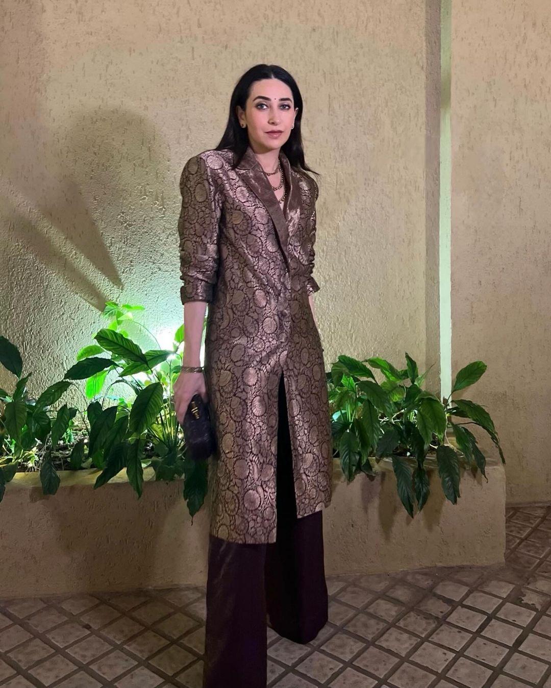 Karisma Kapoor looked stunning at an event in a brown suit-style kurta with a collared neckline. The outfit was both sophisticated and chic, with intricate details on the collar adding structure to the ensemble