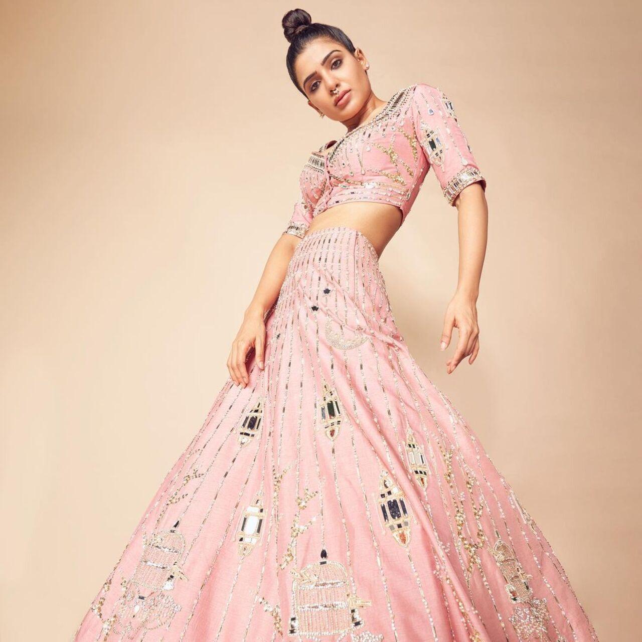 The pastel pink lehenga with shimmery green work is a go to creation for every happy occasion