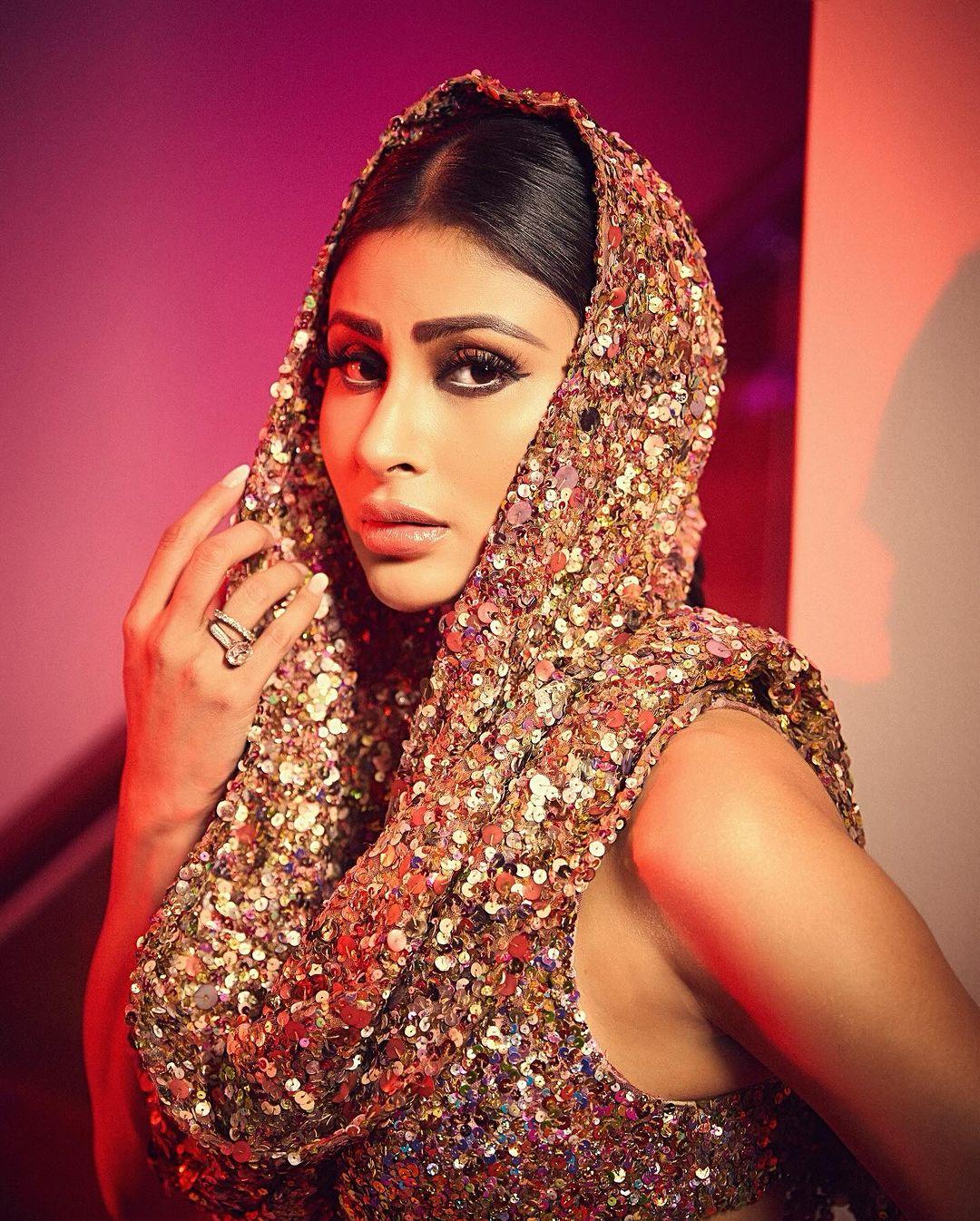 Mouni Roy once again nails the mob wife trend, particularly with her choice of a dazzling golden sequin dress. The actress donned a body-hugging creation from the shelves of Rocky Star. 
