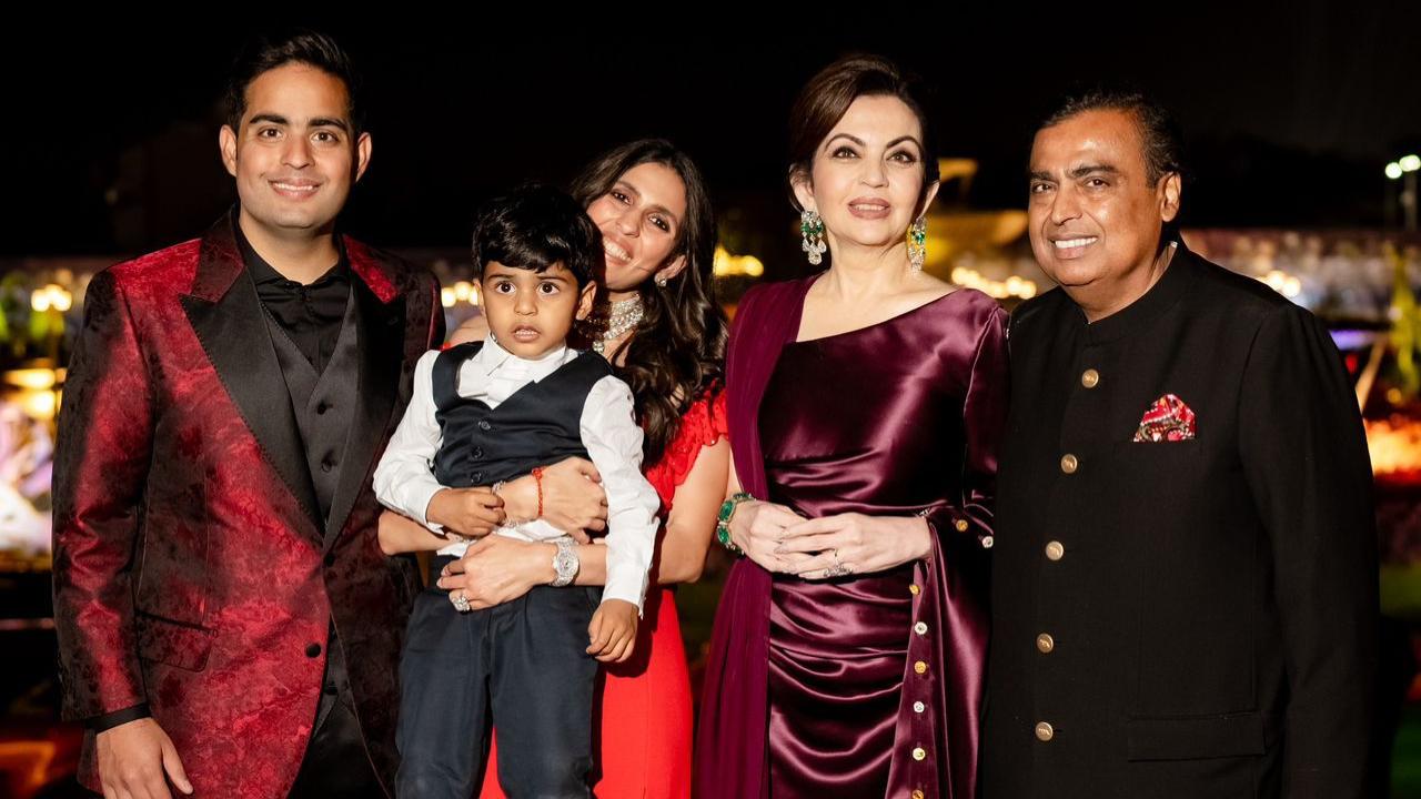 Mukesh Ambani and Nita Ambani proudly pose with their eldest son Akash Ambani, his wife Shloka, and their son