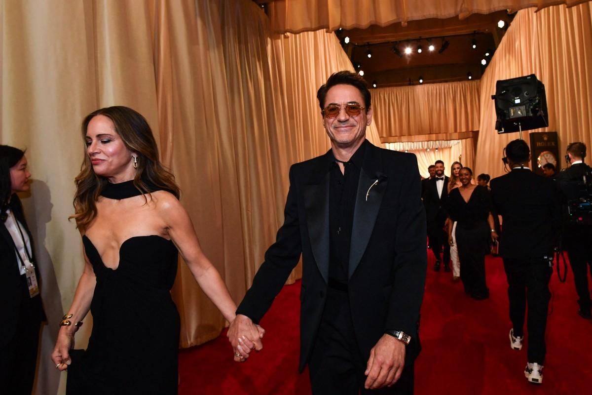 Susan Downey and US actor Robert Downey Jr. attend the 96th Annual Academy Awards. The couple flashed their big smiles and posed for the cameras