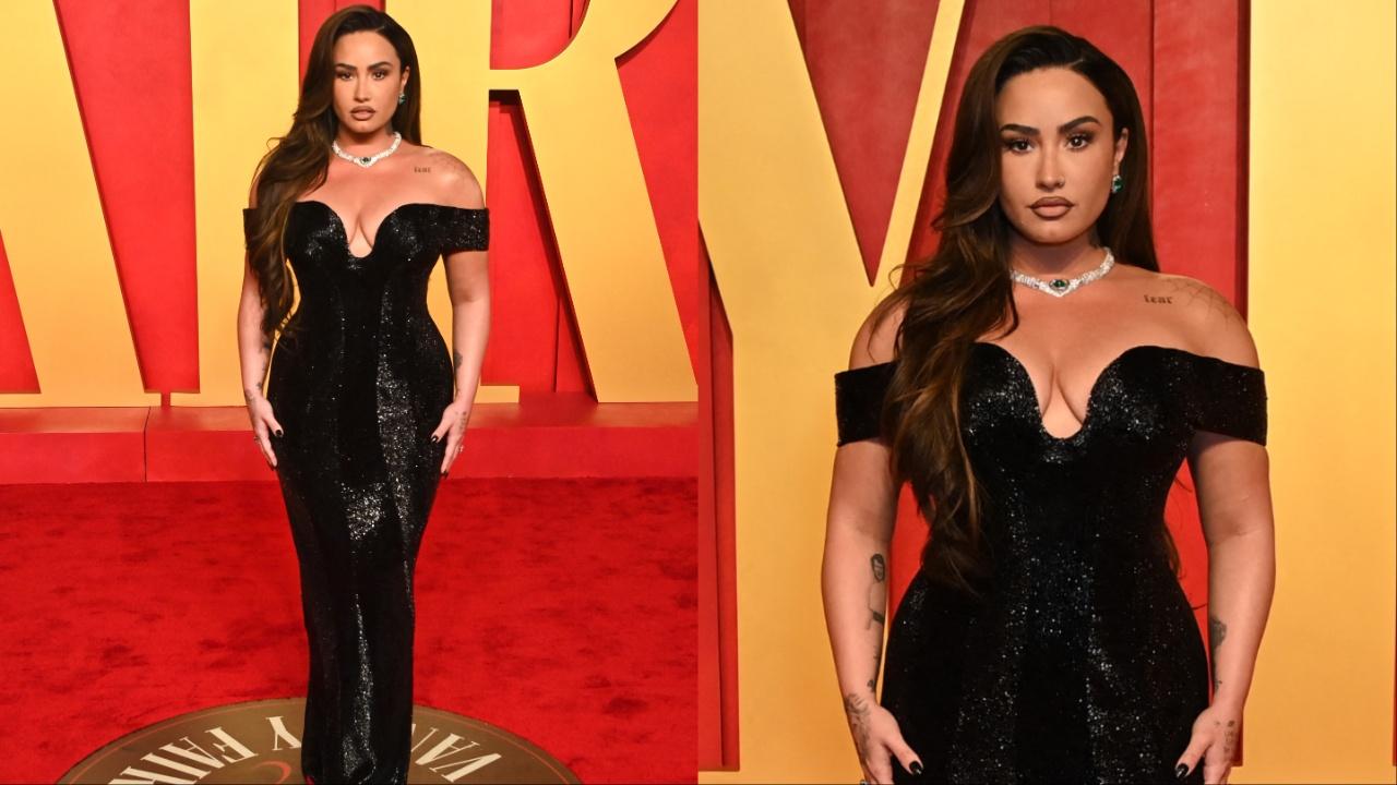 Demi Lovato opted for an off-shoulder shiny black bodycon dress with a plunging neckline. She completed the look with a diamond-studded neckpiece. 
