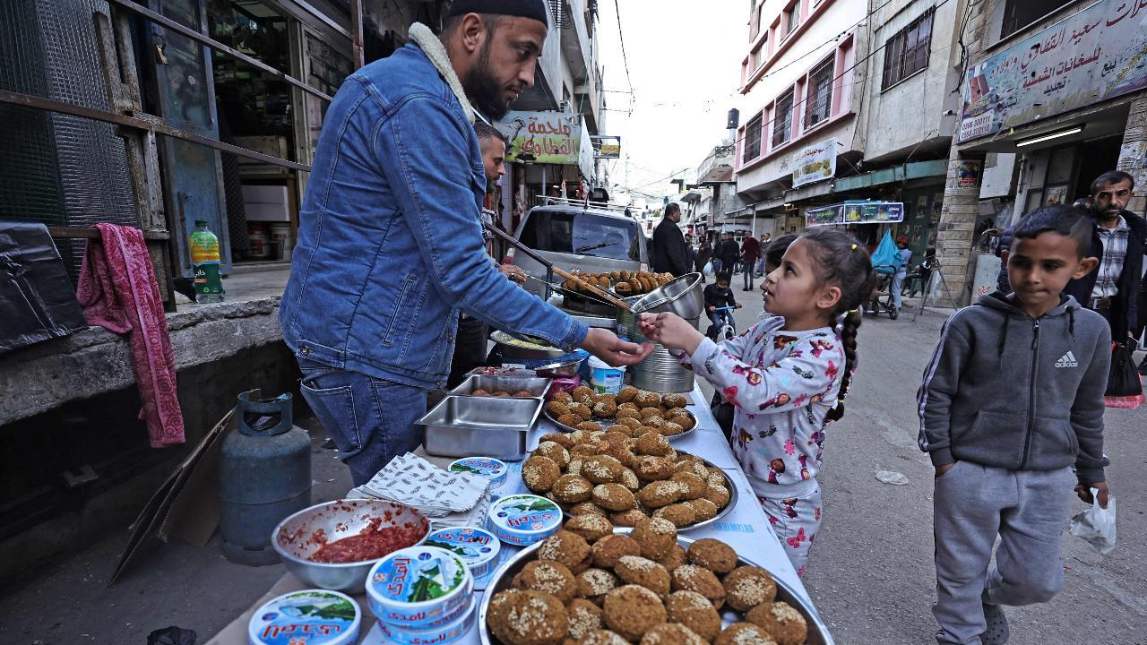 A Palestinian vendor sells falafel in a market during the Muslim holy fasting month of Ramadan at the Balata refugee camp, east of Nablus in the occupied West Bank (Photo by Zain JAAFAR / AFP)