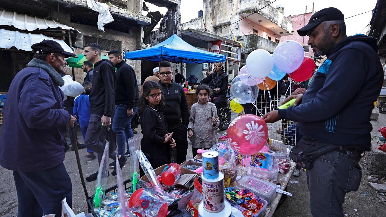 A Palestinian vendor sells toys in a market during the Muslim holy fasting month of Ramadan at the Balata refugee camp (Photo by Zain JAAFAR / AFP)