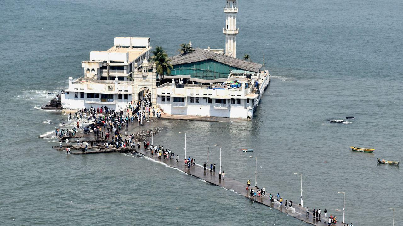 An aerial view of Haji Ali Dargah as devotees arrive to offer prayers during the High tide on the commencement of the month of 'Ramadan', in Mumbai on Tuesday. (Photo by ANI)