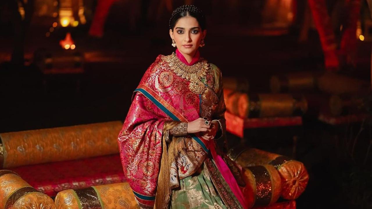 Sonam Kapoor wore a custom outfit by Namza. As per her Instagram post, it is the traditional attire of Ladakh crafted from silk. She completed her look with heritage jewellery borrowed from her mother and mother-in-law. 