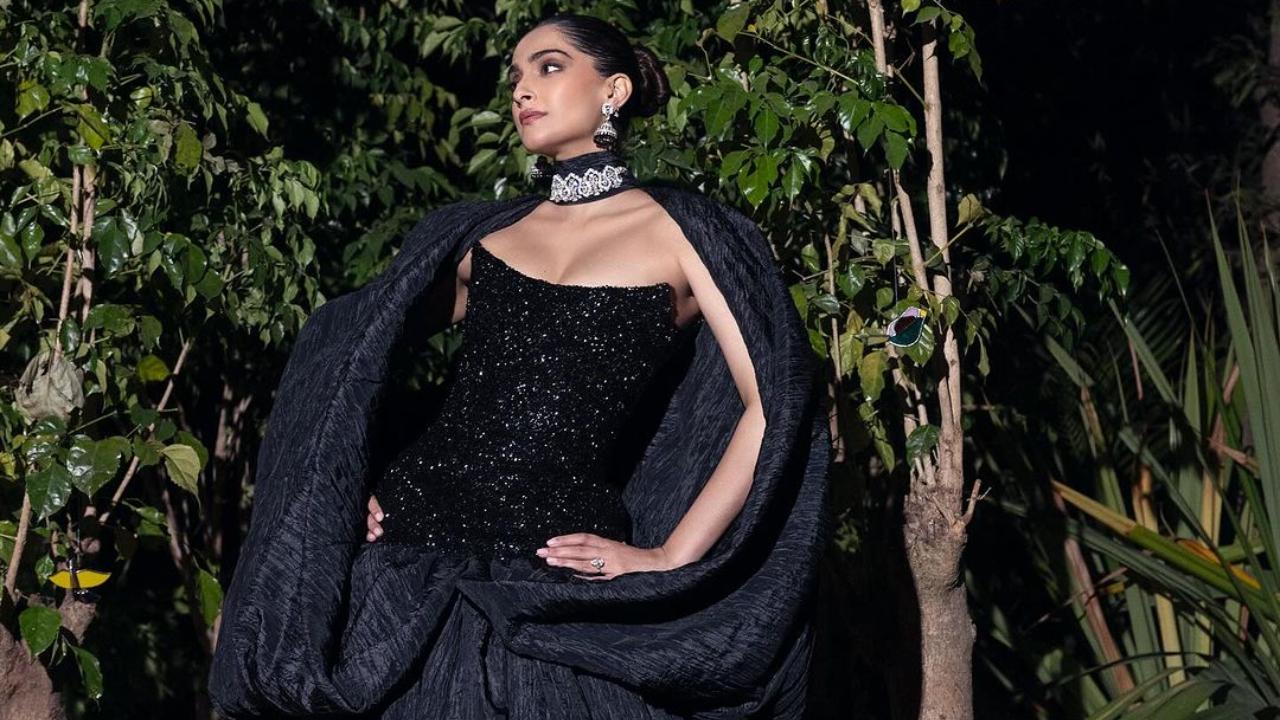 Sonam Kapoor wore a custom Amir Al Kasm ensemble in black. It featured a strapless corset with a cape extending from the neck. 