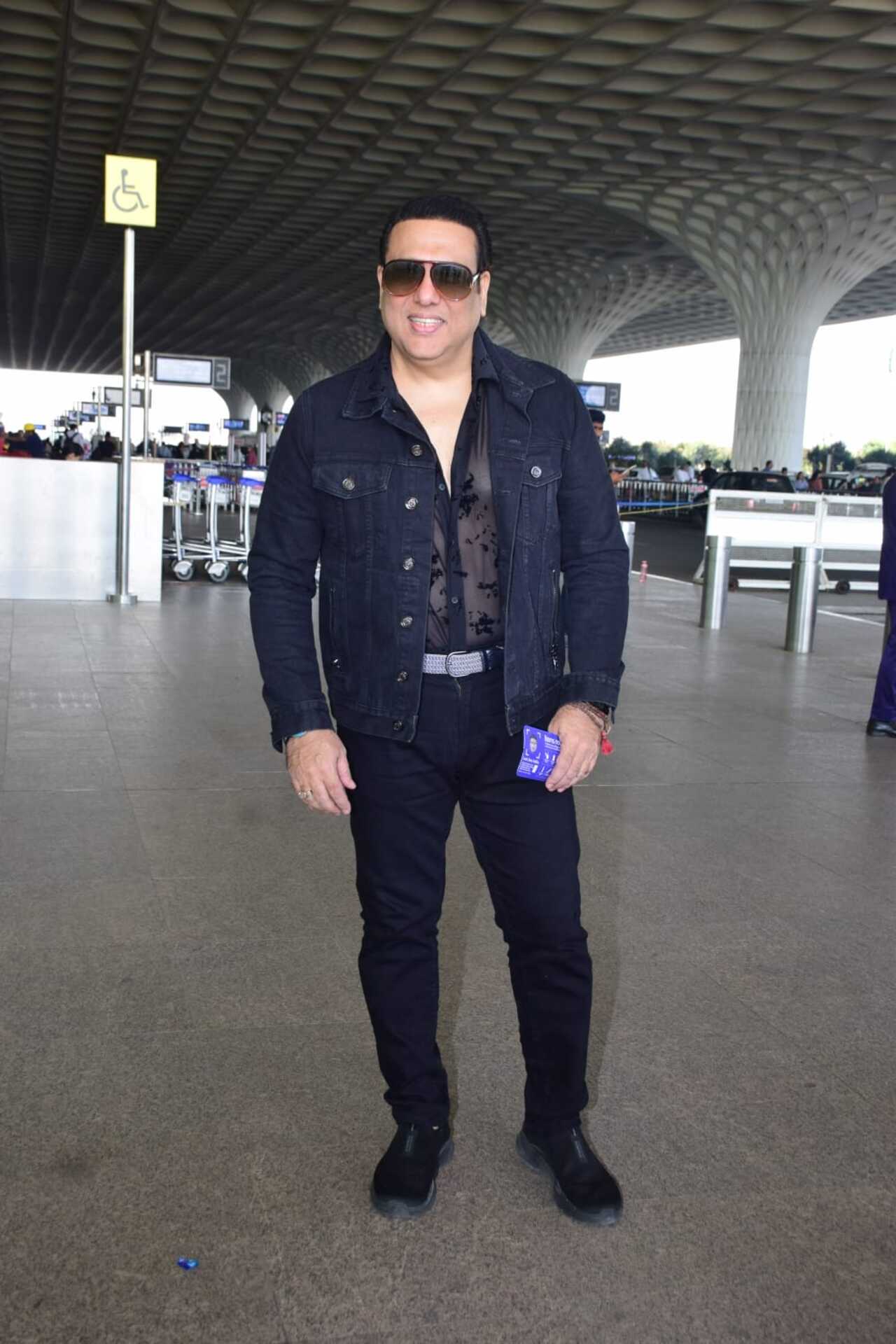 Govinda strikes a pose for the paparazzi at the Mumbai airport