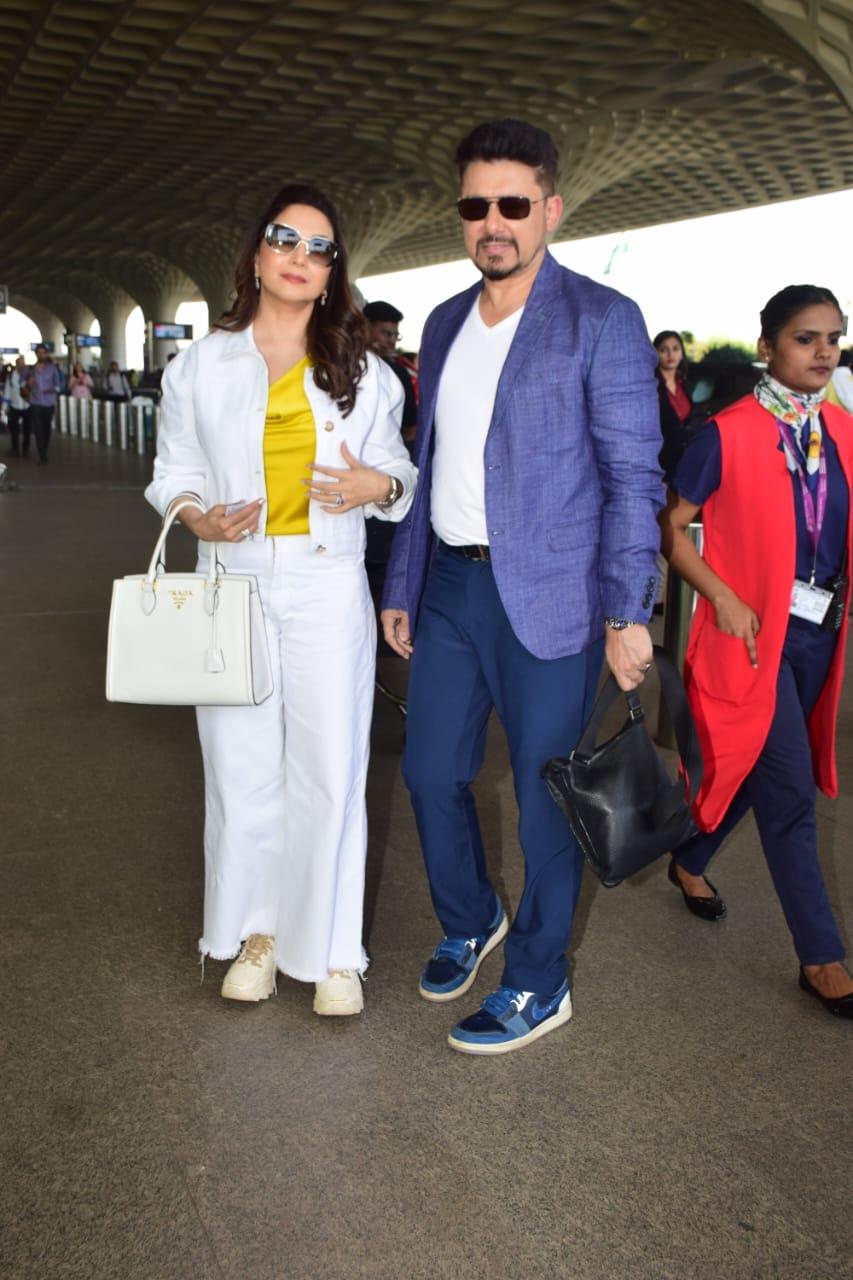 Madhuri Dixit and her husband Dr Sriram Nene were photographed at Mumbai T2 airport. The couple looked too fabulous for words as they posed for the cameras
