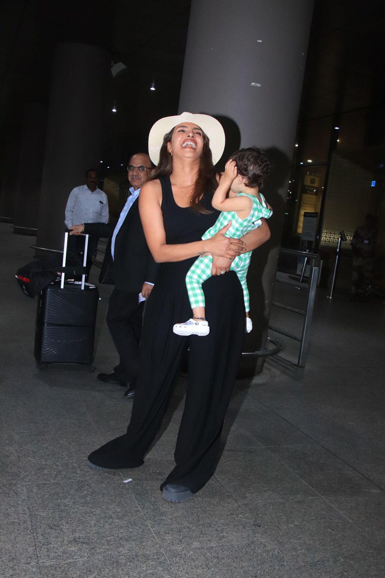 Priyanka Chopra Jonas has a laugh out loud moment as she poses for the paparazzi with her daughter