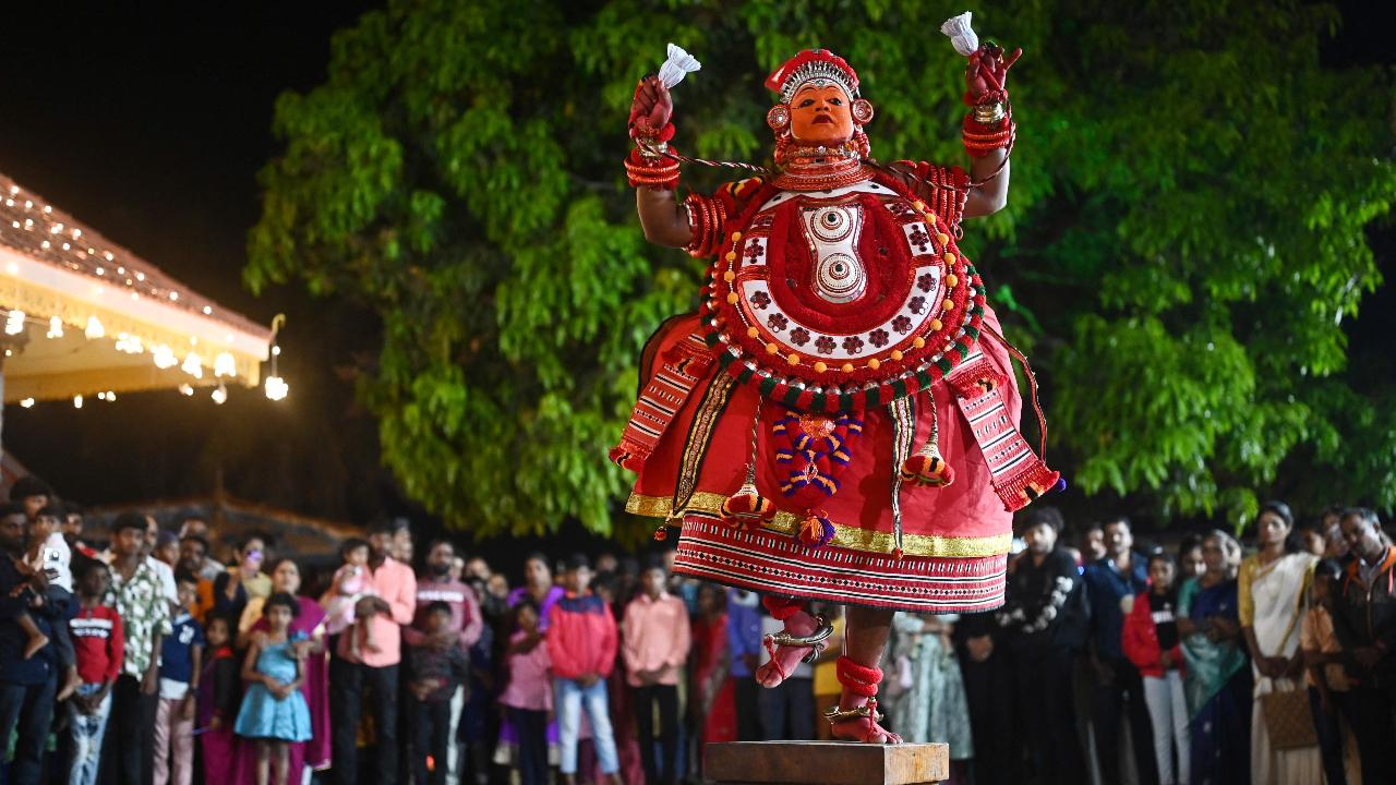 A man, dressed as the Hindu deity Sasthappan, performs during the traditional dance festival 'Theyyam' 