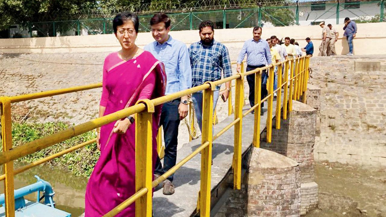 Minister Atishi inspects Wazirabad water treatment plant. Pics/PTI