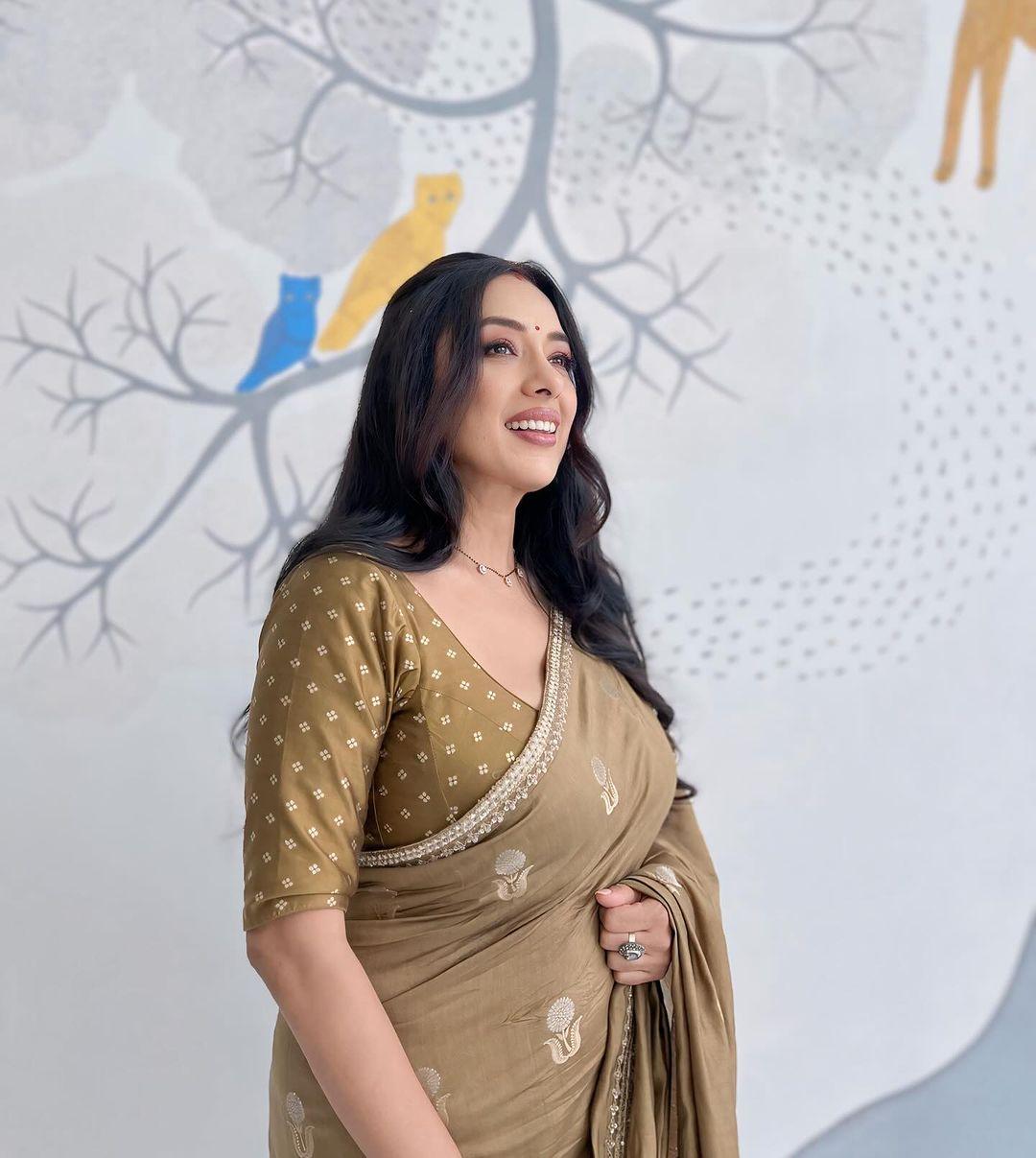 In this look, the actress wore a light brown saree and paired it with a matching blouse. She put her hair in a clutch and with minimal jewellery and less makeup, made this look a must-have