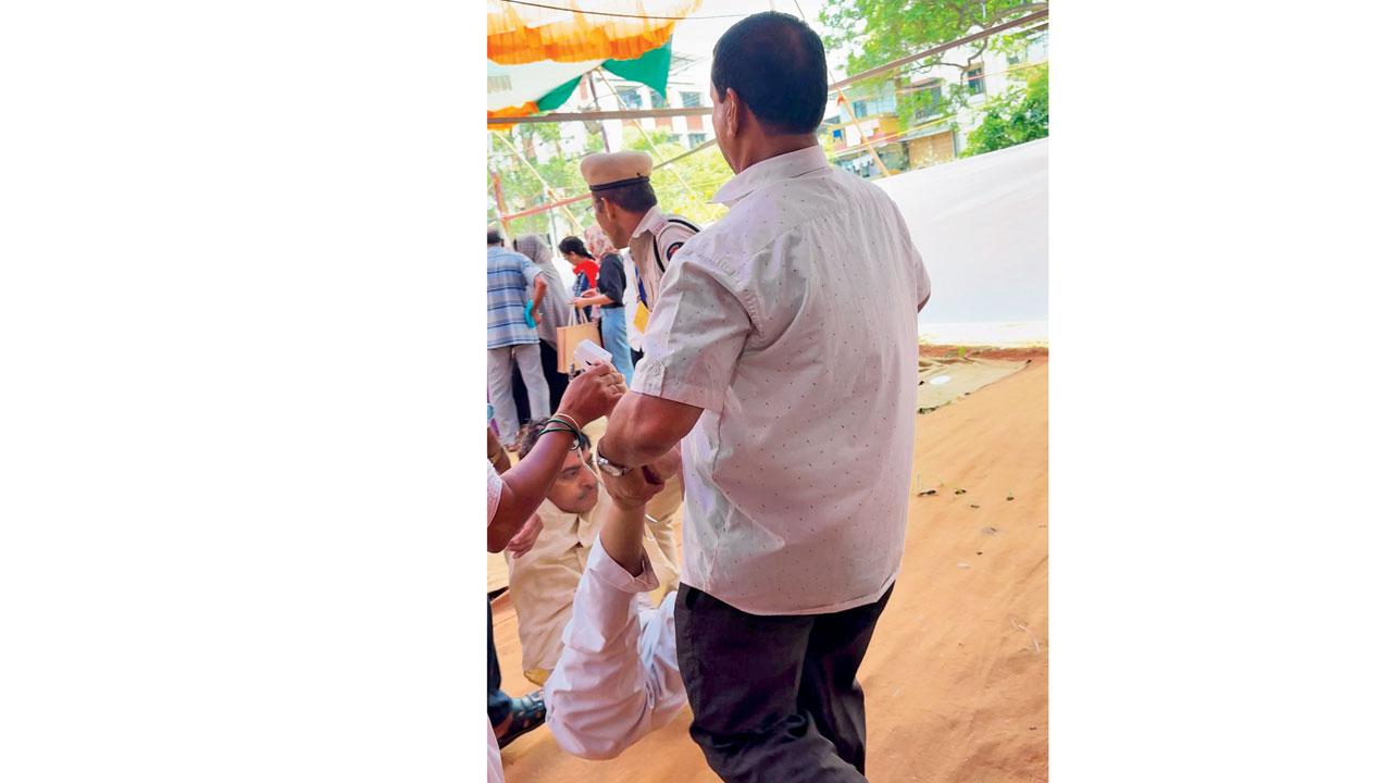 Ashok Tiwari, who collapsed at a polling centre at Vasai, being carried away. Pic/Hanif Patel