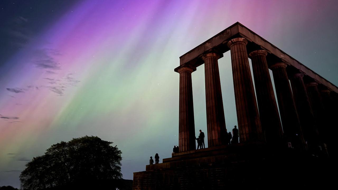 This handout photo taken and released by Jacob Anderson shows the northern lights or aurora borealis during a solar storm over the National Monument of Scotland in Edinburgh on May 10. Photos Courtesy: AFP