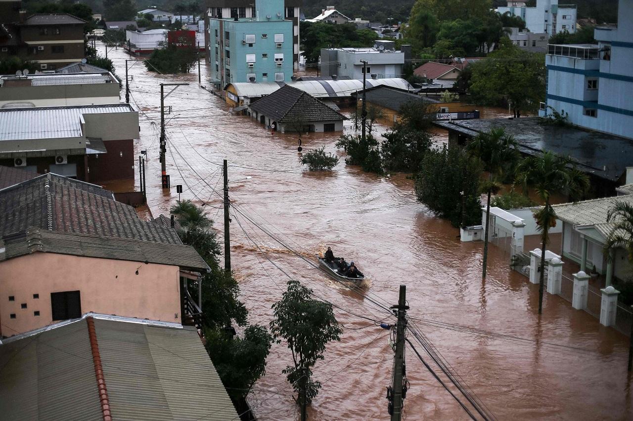 Part of the structure of a hydroelectric dam gave way on Thursday. More than 10,000 people have been forced from their homes, according to the civil defense agency