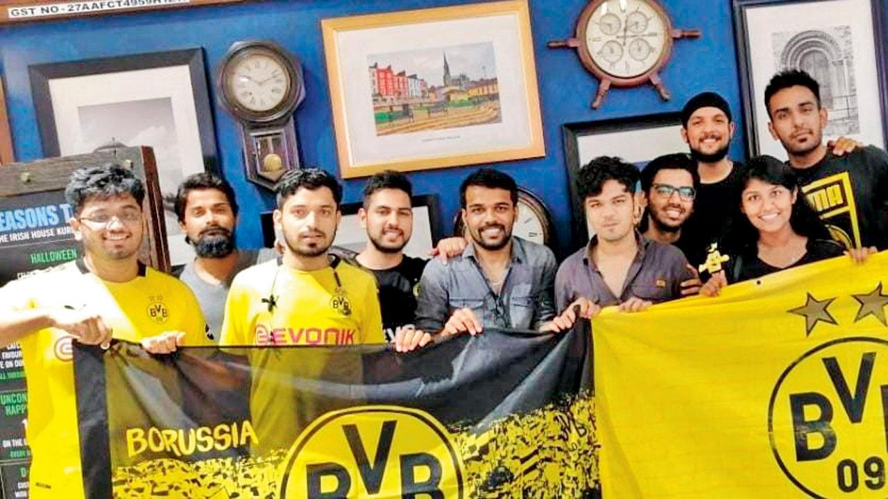Borussia Dortmund fans hold up the team flag at a meet-up