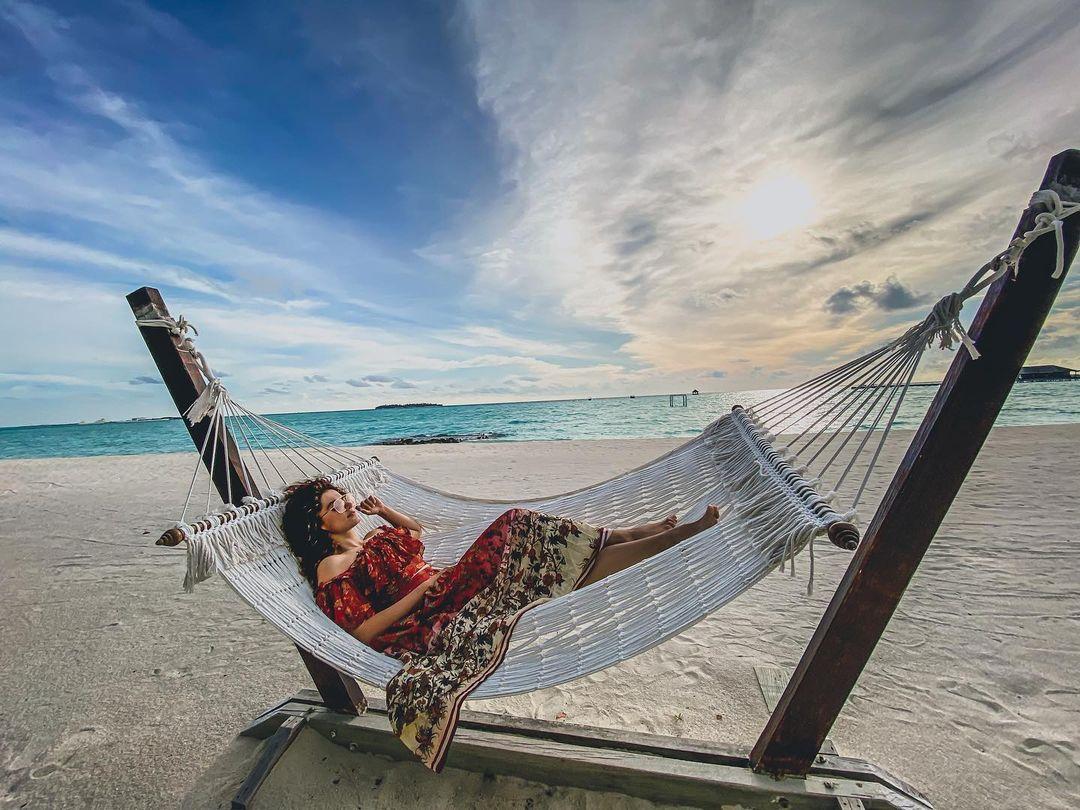 At an empty, clean beach, lying in your comfy outfit and enjoying the sun has to be your vacation plan, just like Taapsee Pannu