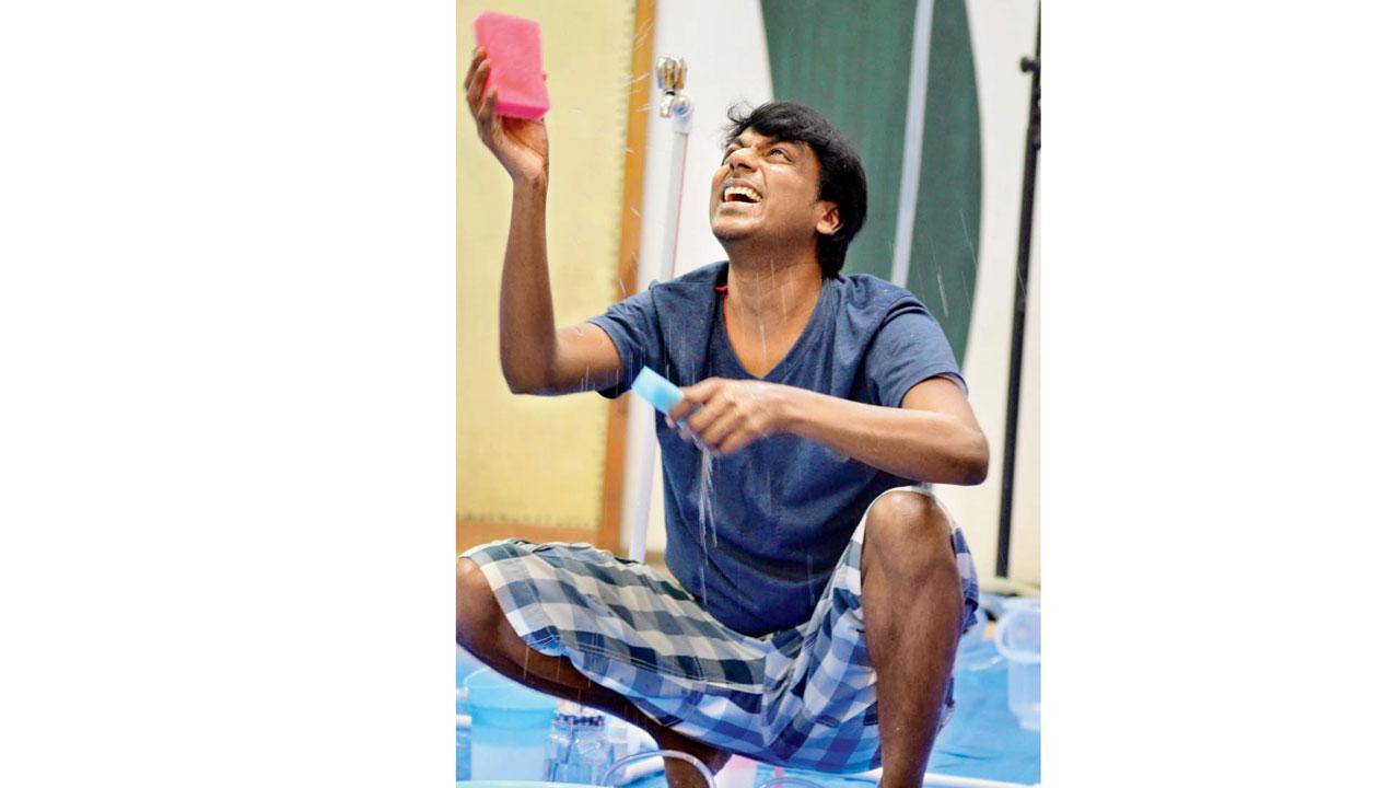 Kawade plays with water in the opening scene of the play