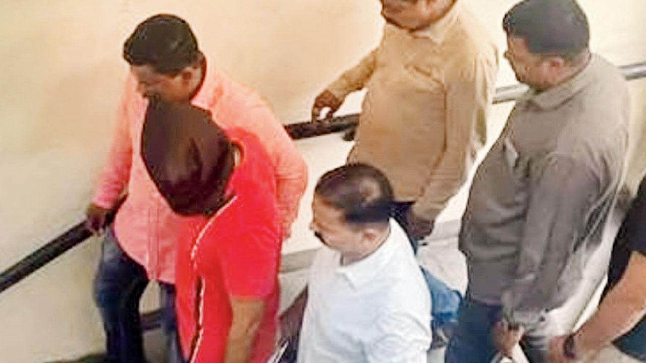 Malay Mehta being escorted by Thane Crime Branch officials following his arrest in Nashik. The accused was on the run following the blast. 