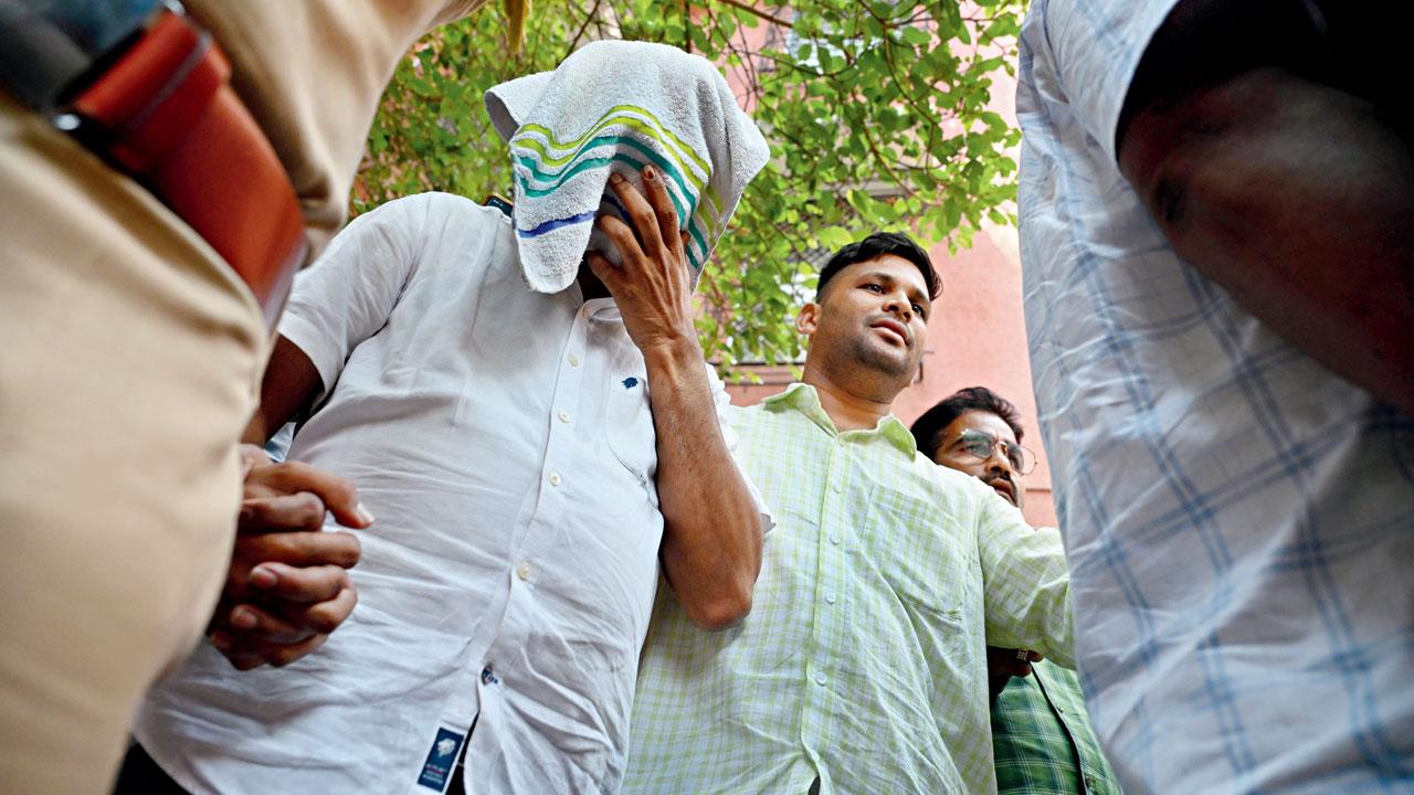 Police escort Dr Rajesh Dhere, after he was released on bail. Pic/Atul Kamble