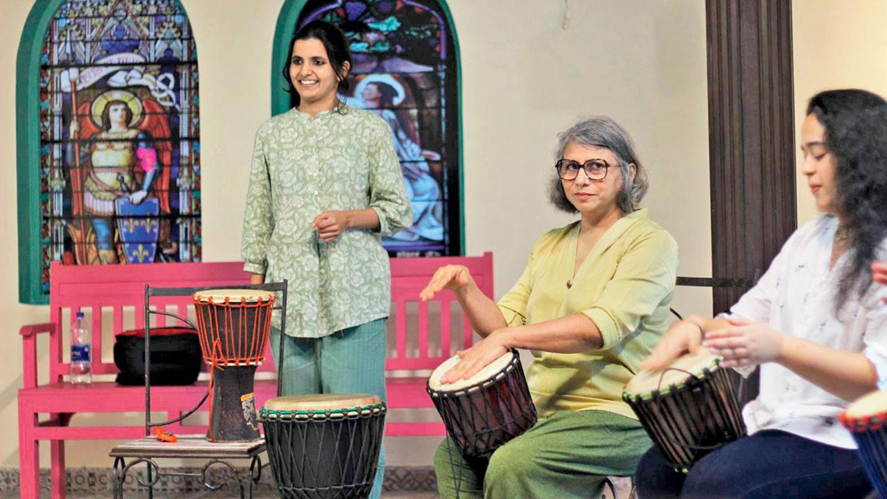 Participants form a drum circle