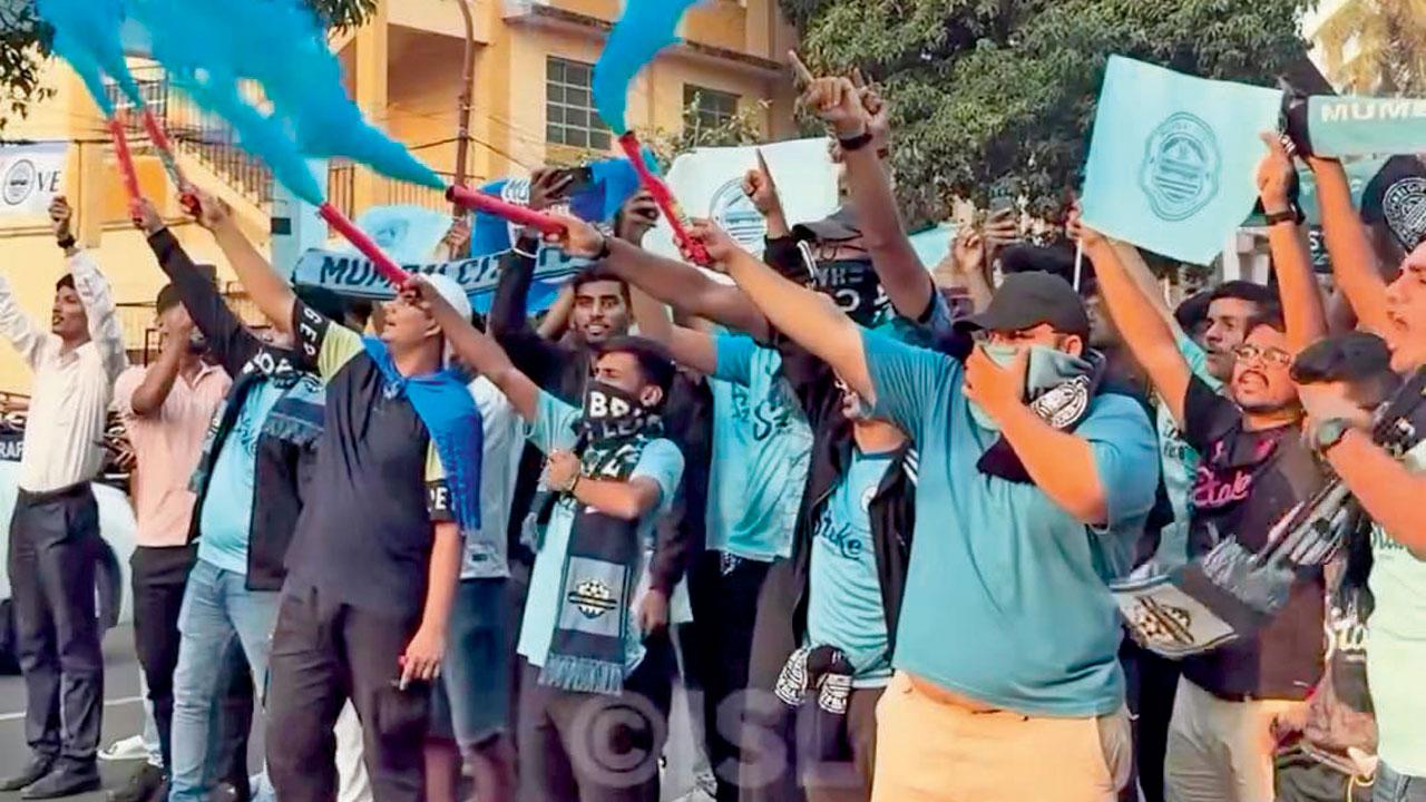 Fans set off blue smoke to welcome the Mumbai team in Goa in April