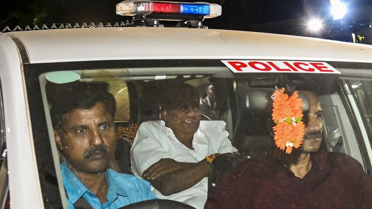 Karnataka JD(S) MLA H.D. Revanna being taken into custody by officials of a Special Investigation Team. Pics/PTI