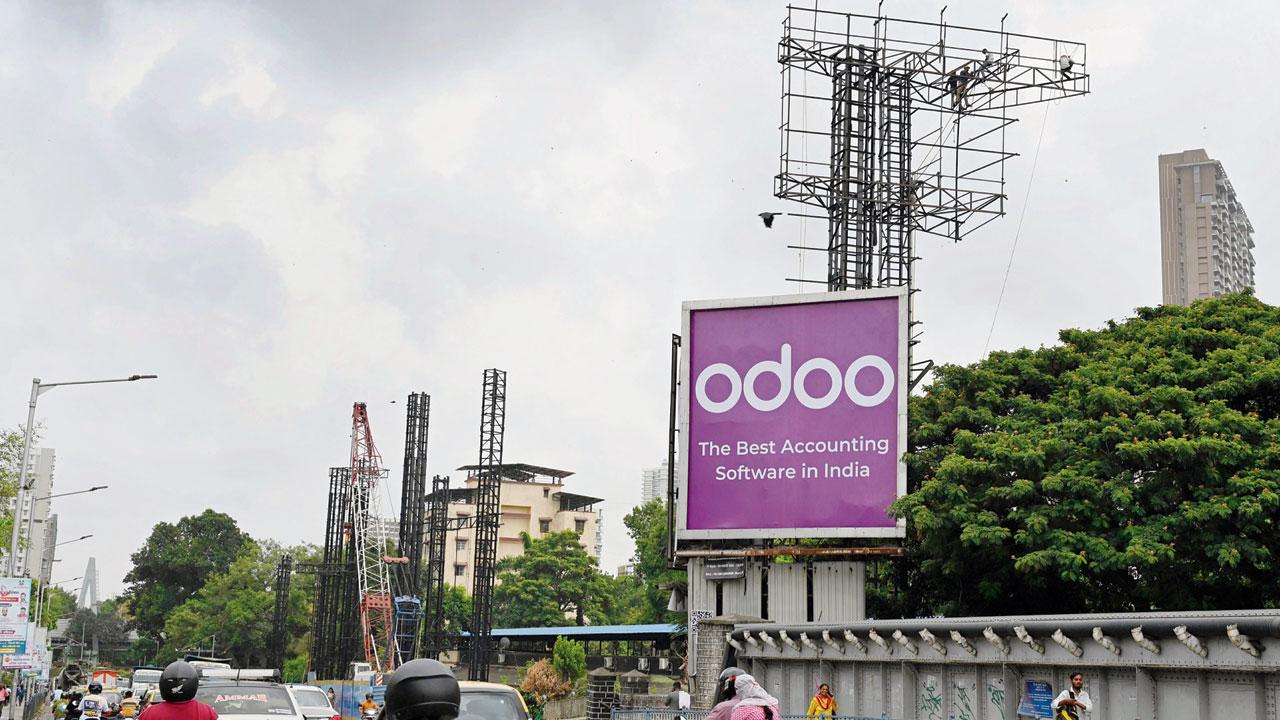 BMC demolishes the illegal hoardings in Dadar. Pic/Ashish Raje