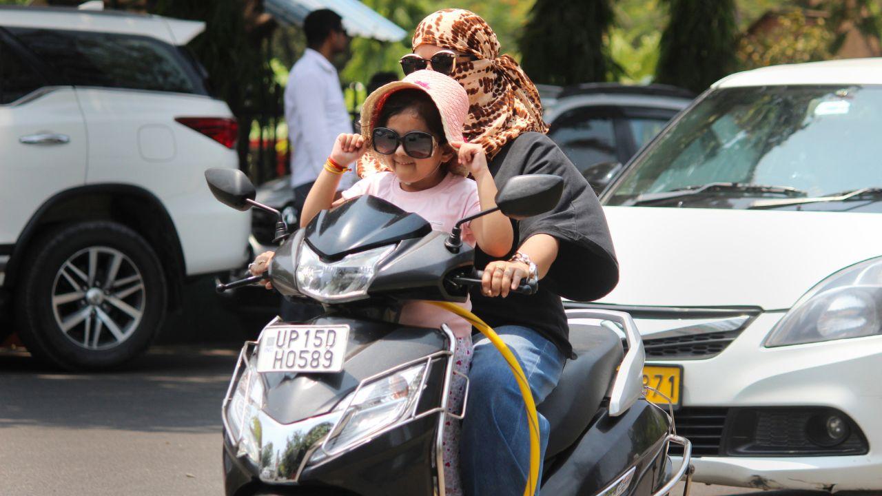 Commuters cover themselves for protection from the scorching sun on a hot summer day, in Meerut, Friday, May 24, 2024. (PTI Photo)