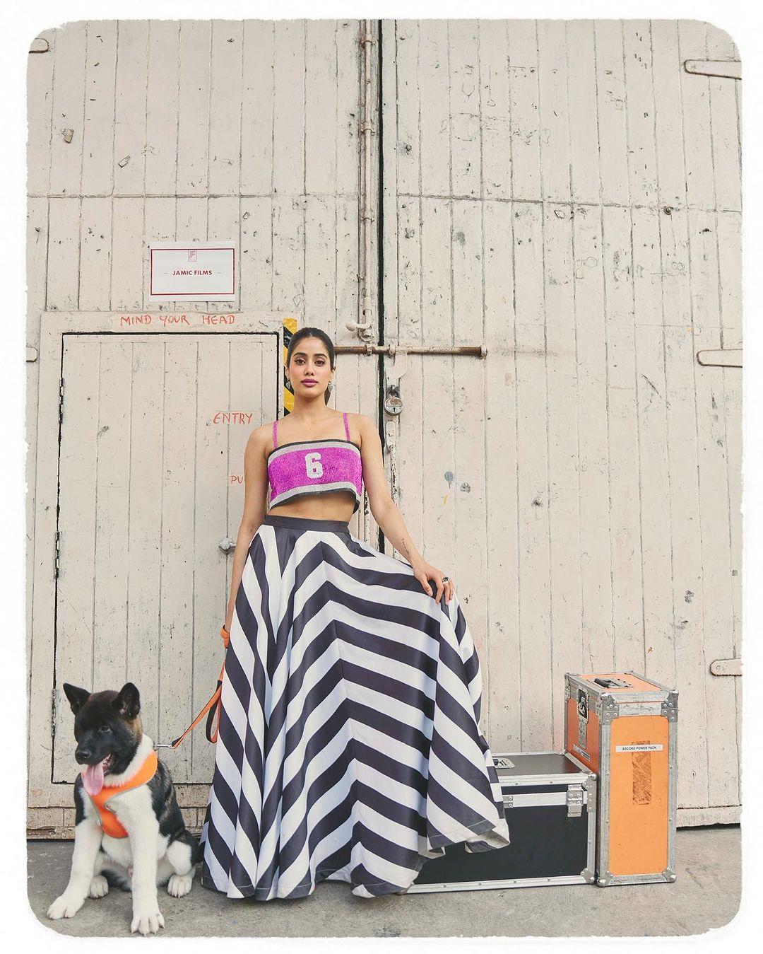 In another look, Janhvi opted for a purple crop top and paired it with a long black and white striped skirt