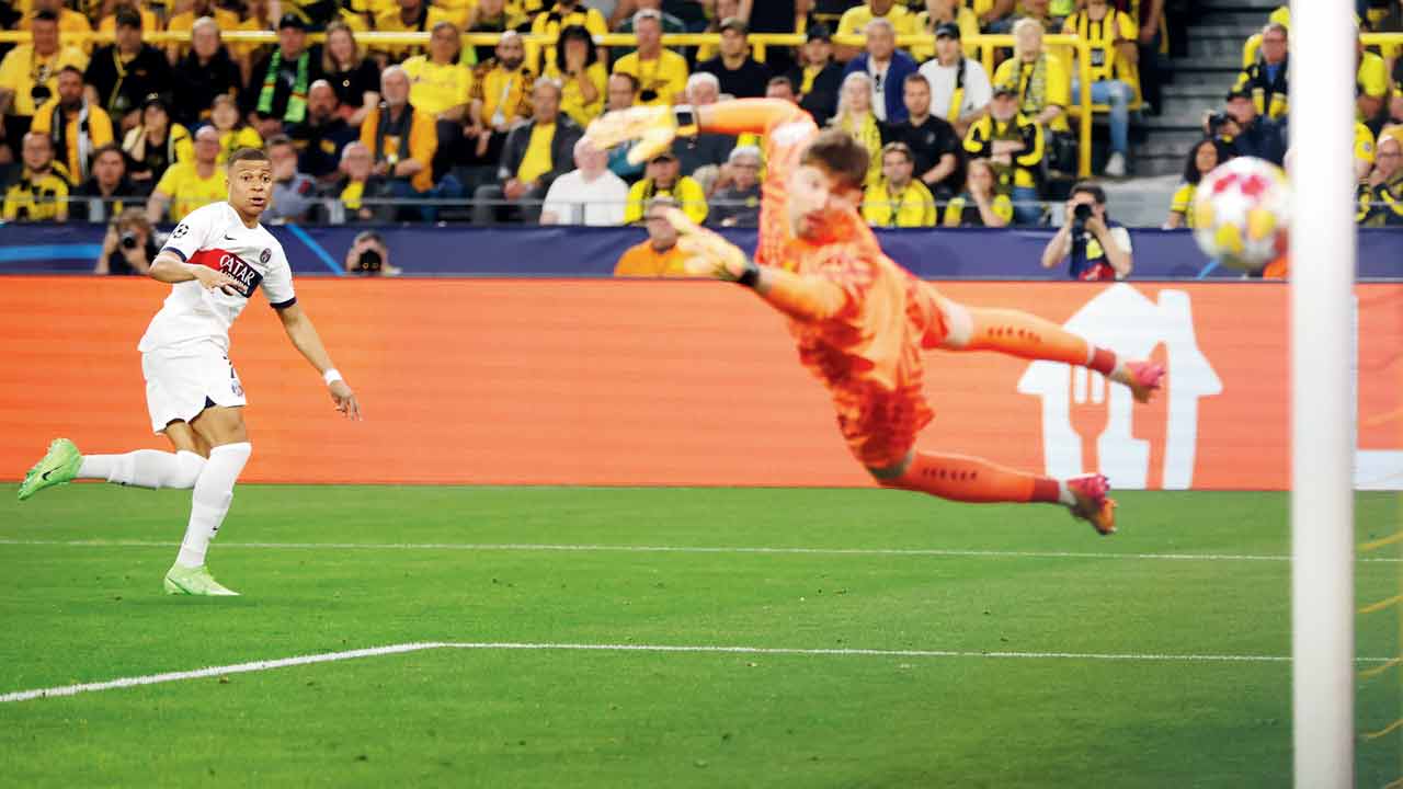 PSG’s Kylian Mbappe (left) shoots wide against Borussia Dortmund