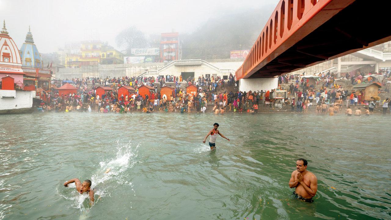 Devotees take a dip in the Ganga. “Before every Kumbh, a budget is allotted to it. Mega infrastructure projects are  taken up, bridges are built and accommodation is constructed. They often just build a new city.”