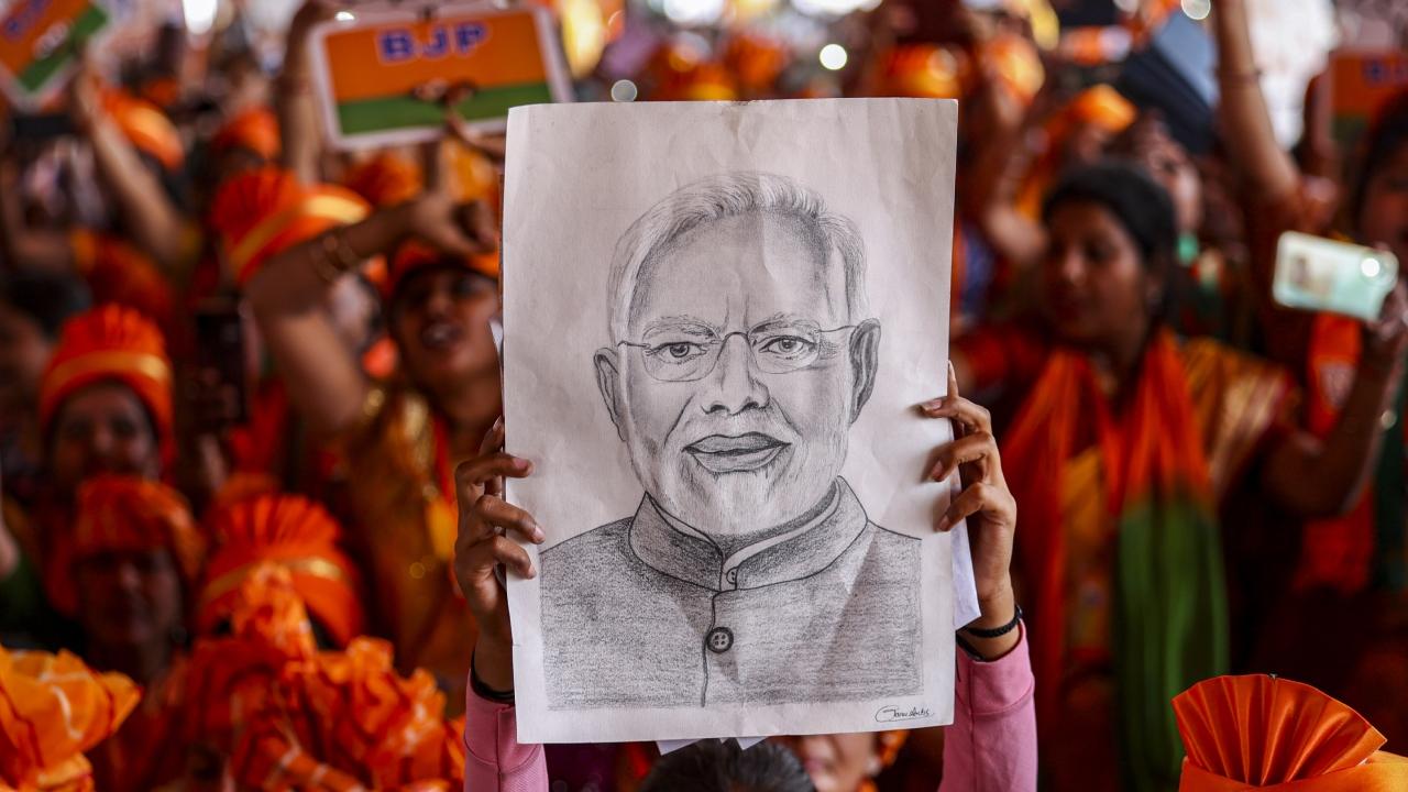 A supporter was seen with a sketch of PM Modi at the rally