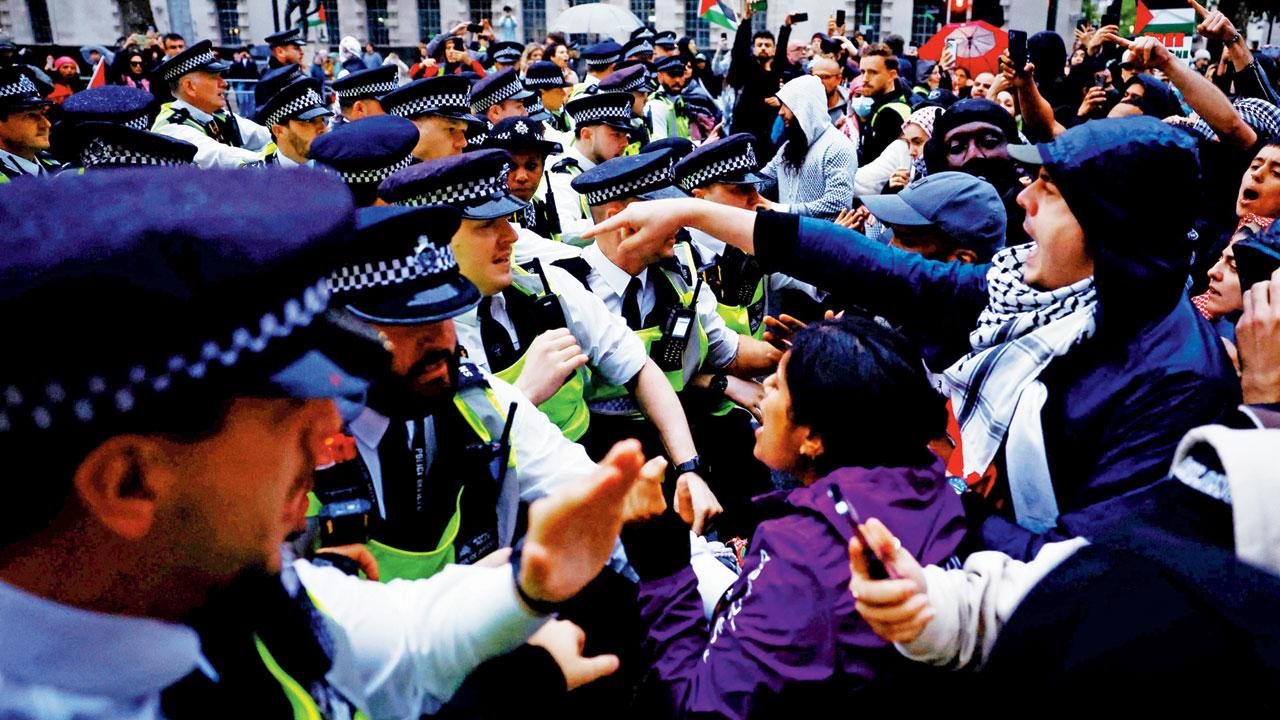 Police officers clash pro-Palestinian protesters during outside Downing Street, central London