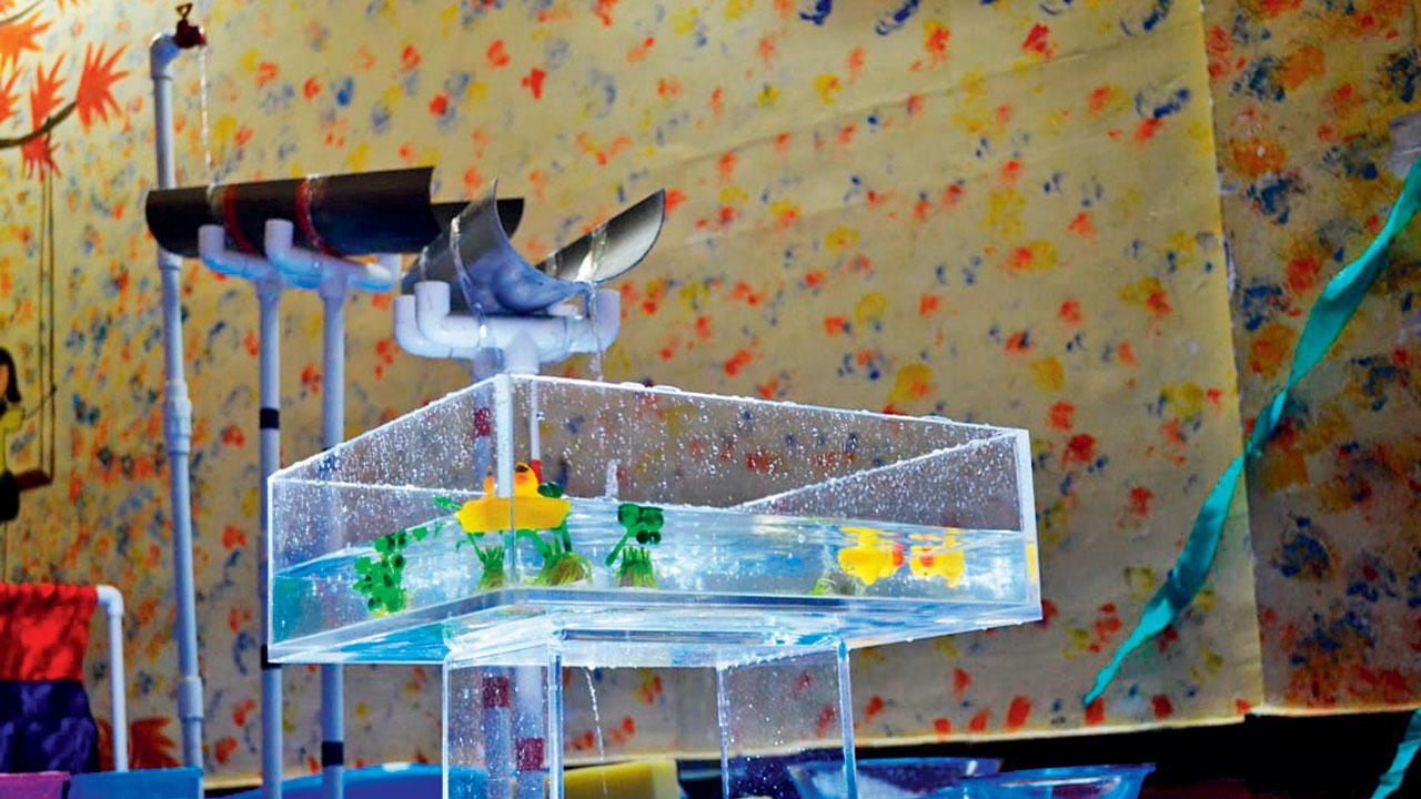 A glass tank filled with water and miniature rubber ducks acts as a visual cue for the audiences to revisit memories from their childhoods involving water