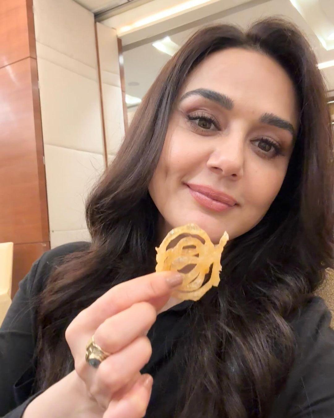 Preity Zinta prefers a simple and understated beauty look often showcasing natural hair and makeup on her Instagram, reminiscent of the iconic 90s girl-next-door.
