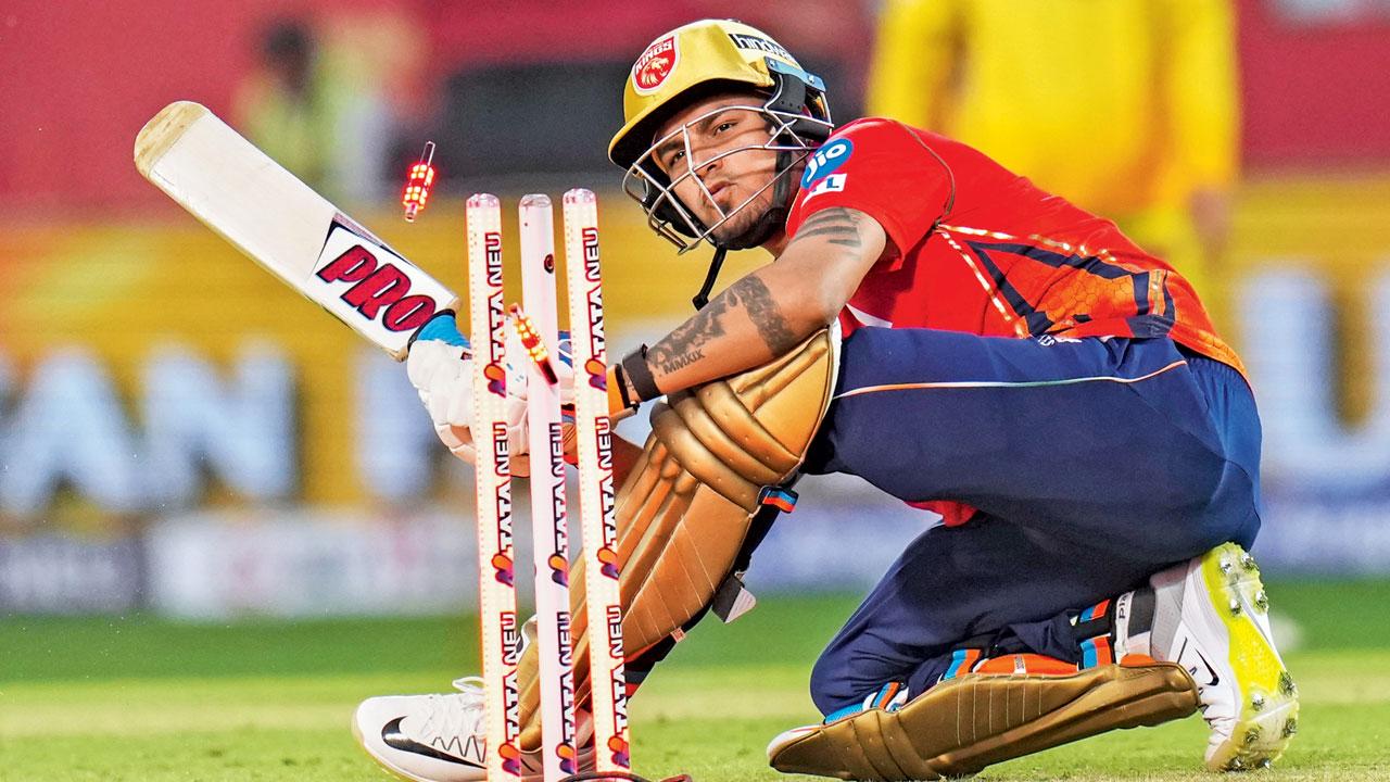 Punjab Kings’s Rahul Chahar is clean bowled by CSK pacer Shardul Thakur. Pic/PTI