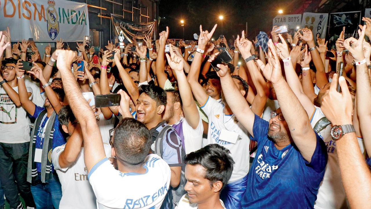 Real Madrid fans cheer for the team at a previous official screening of a football match