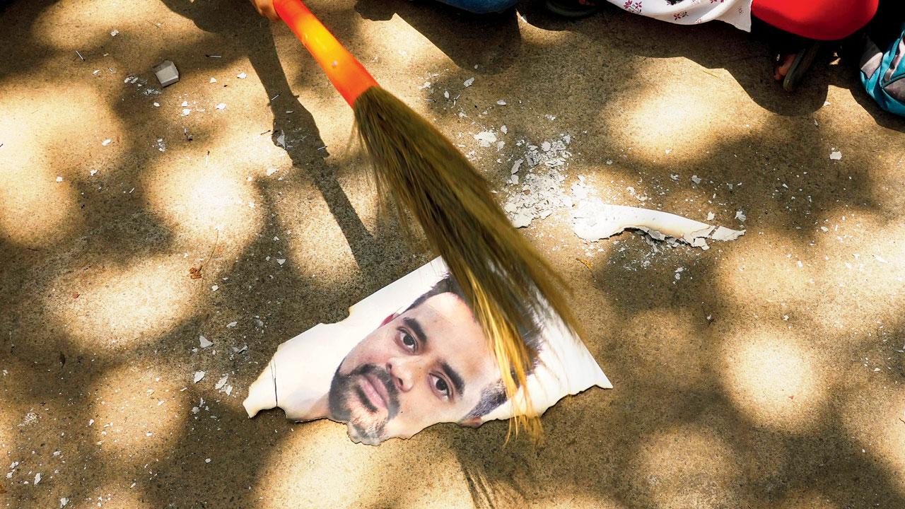 A half-burned poster of Prajwal. Pic/PTI