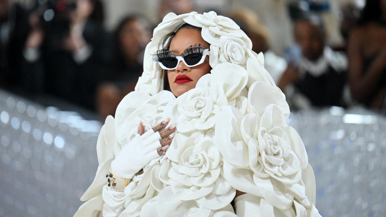 Barbadian singer/actress Rihanna arrived for the 2023 Met Gala with a unique appearance and she immediately grabbed eyeballs with her dress that depict white flowers. 
