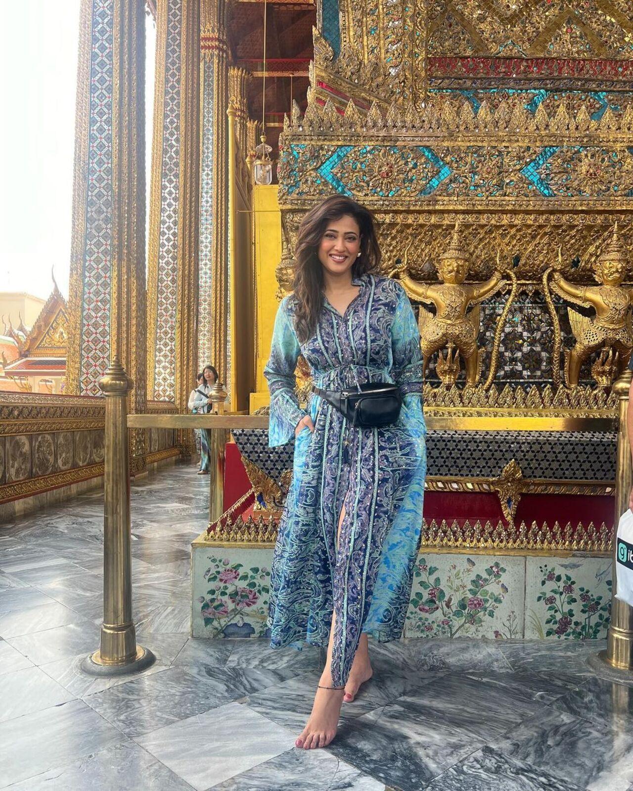 She wore a cotton indigo dress to visit a temple at the exotic destination and posed with its mesmerising interiors in the background. 