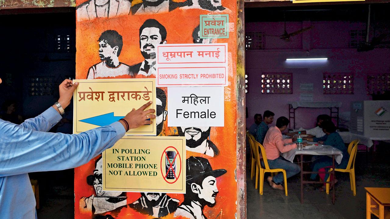 Stickers showing ban on mobile phones put up at a polling booth in Dharavi. PIC/ASHISH RAJE