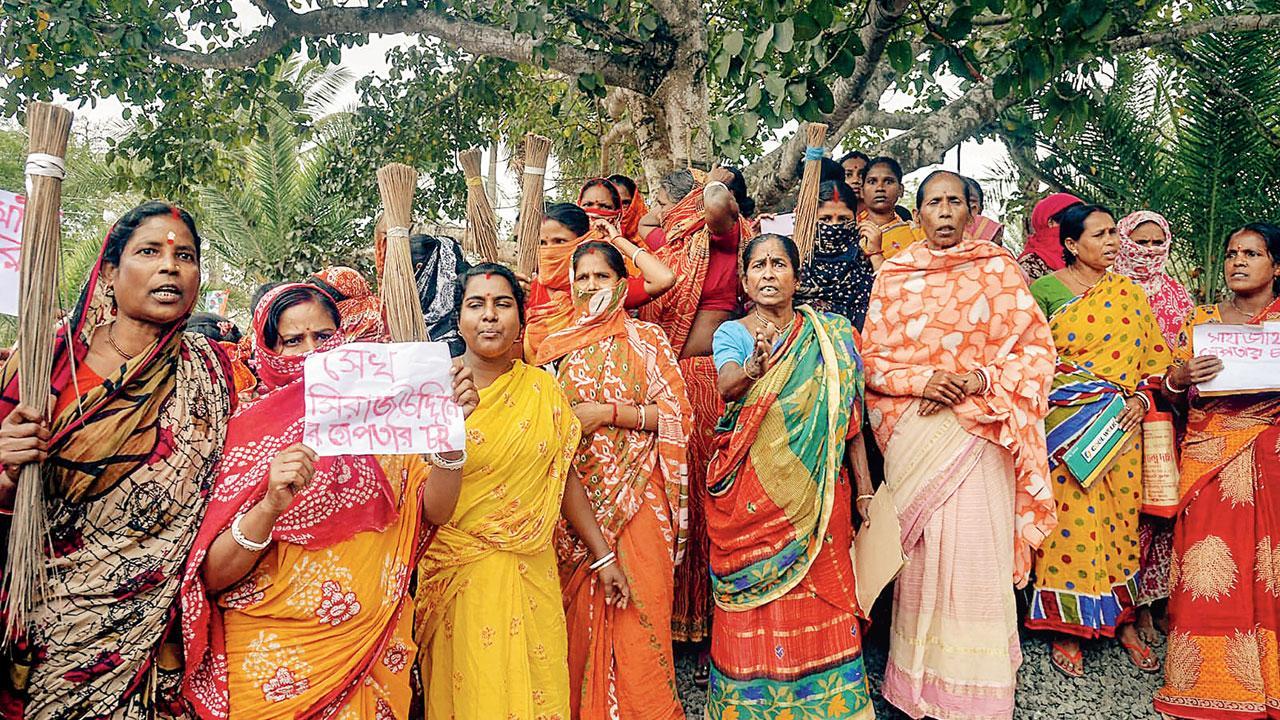 Women holding posters stage a protest over Sandeshkhali incident allegations. File pic/PTI