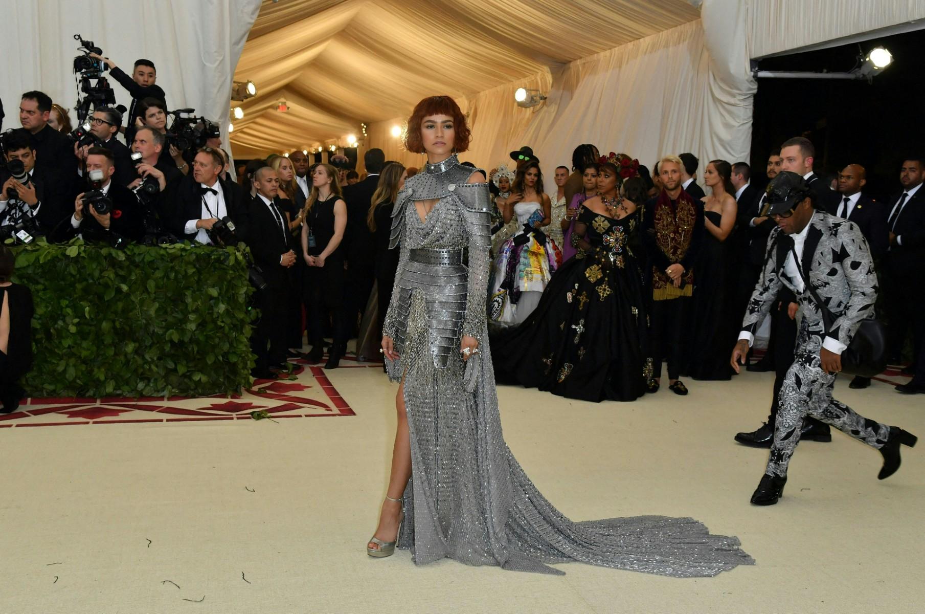 Zendaya always knows how to make a grand entrance at the Met Gala. In 2018, she stunned everyone with a custom Versace gown inspired by Joan of Arc, perfectly matching the theme of 