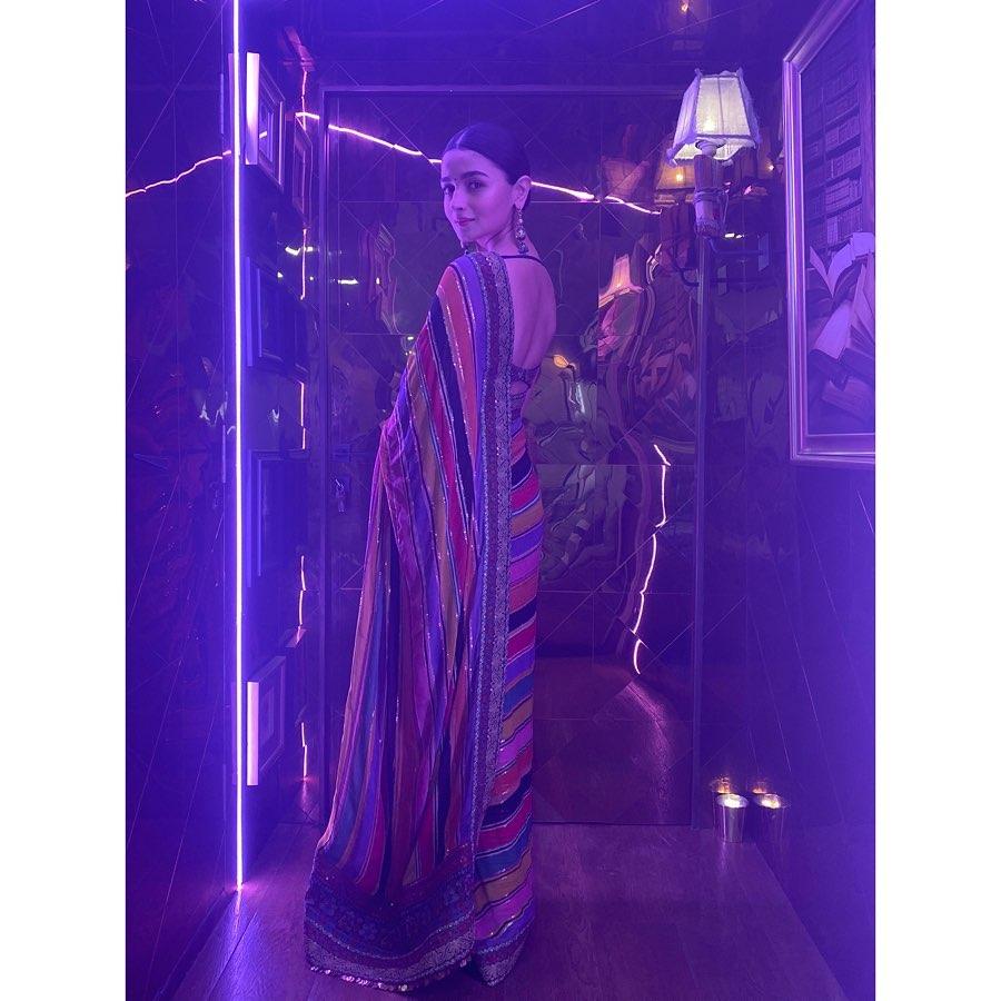 In this look, Alia Bhatt wore her multi-coloured saree with a strappy blouse, adorned with detailed threadwork, evoking a bohemian vibe