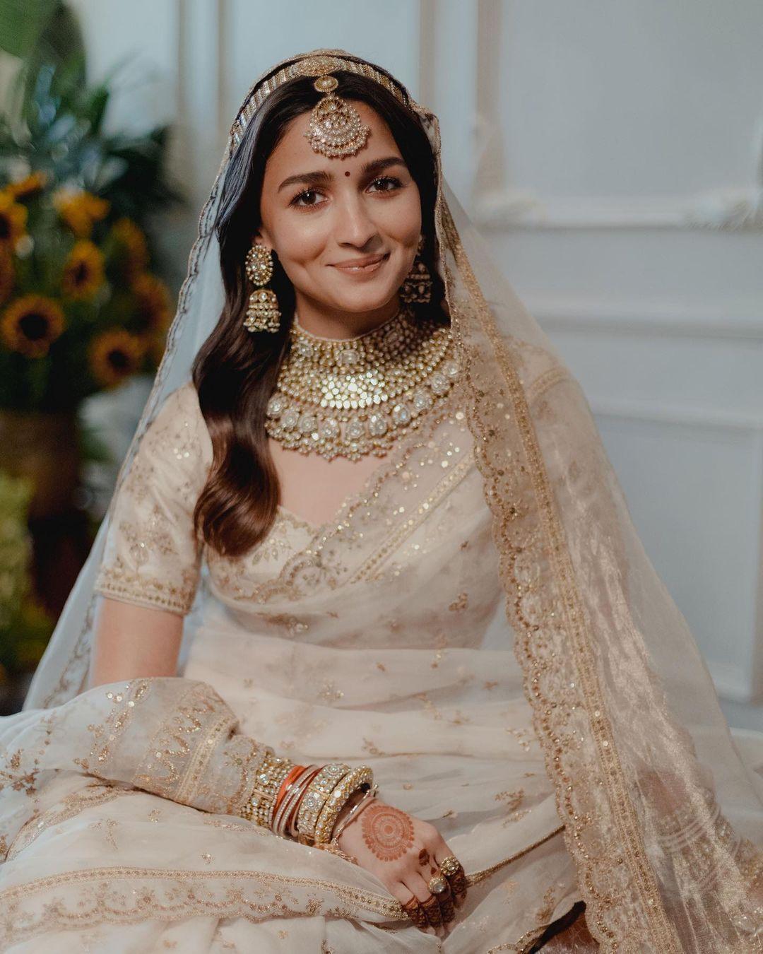 The actress wore a stunning white, heavily embroidered saree by Sabyasachi Mukherjee on her wedding day. She paired the embroidered saree with a matching blouse and a beautiful long veil