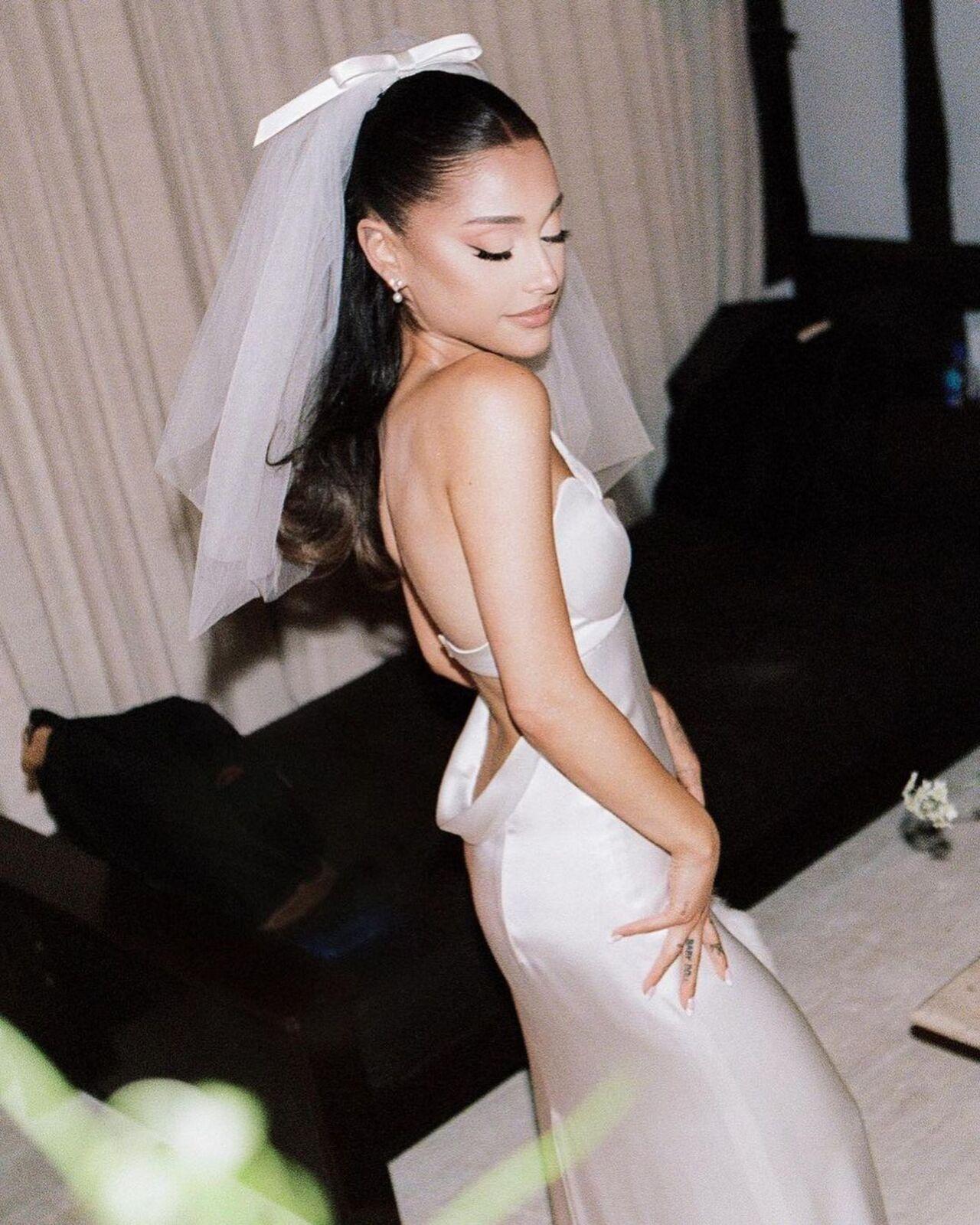 Ariana Grande got hitched to her beau and real estate agent Dalton Gomez in an intimate ceremony in 2021. She wore a Vera Wang Haute dress with a beautiful veil and a bow paired with the songstress' signature ponytail. The dress featured a sweetheart neck, a low-cut back, and a slit around the leg space.