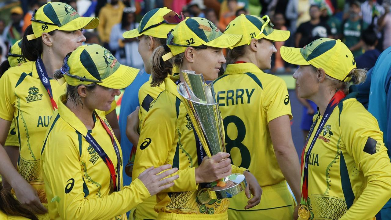 Australia`s Tahlia Mcgrath (C) holds the trophy after Australia won the final T20 women`s World Cup cricket match against South Africa at Newlands Stadium in 2023 (Pic: AFP)